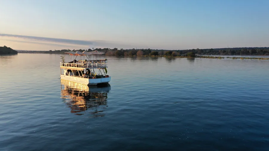 The Bamba Boat on a glassy Zambezi at dusk