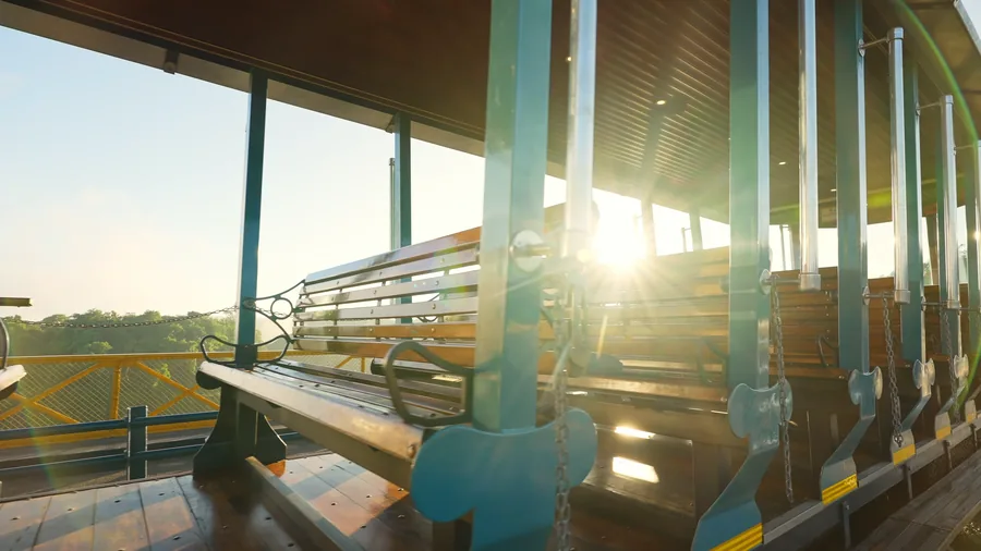 Morning sun through the tram's wooden benches